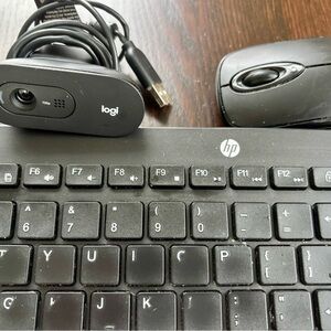 HP Black Keyboard with Logitech Webcam, mouse and speakers.